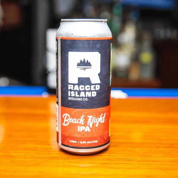 A can of Ragged Island Brewing Co. Beach Night IPA on a wooden bar top.